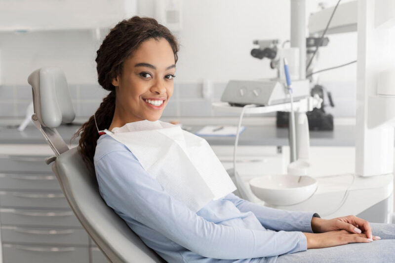 lady sitting in dentist chair and smiling